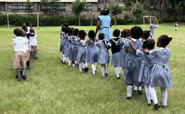 Children in circle with caregiver